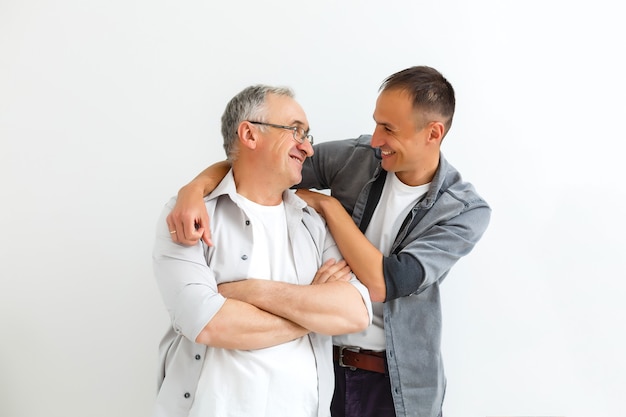 Senior Father With Adult Son isolated on white wall