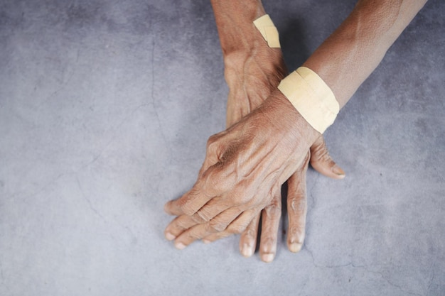 Senior hands with gauze bandage wrapped around