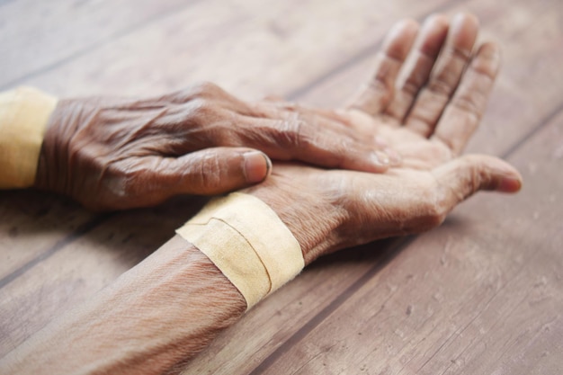 Senior hands with gauze bandage wrapped around