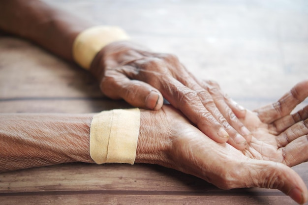 Senior hands with gauze bandage wrapped around