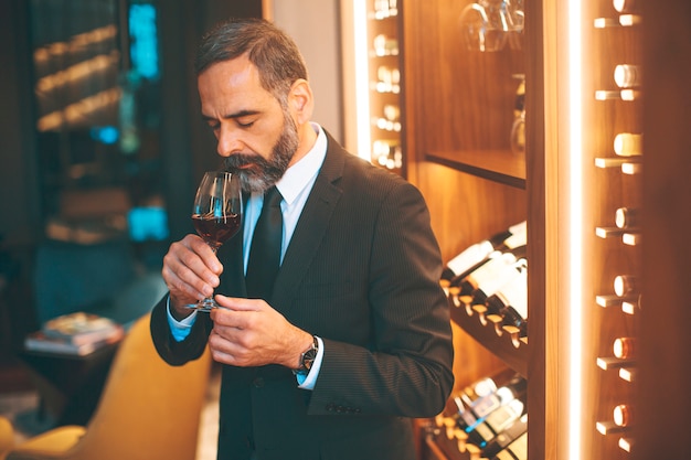 Senior handsome man drinking red wine