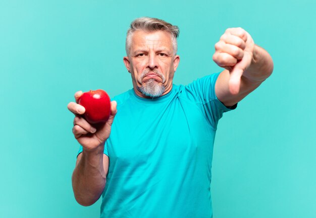 Senior handsome man with an apple