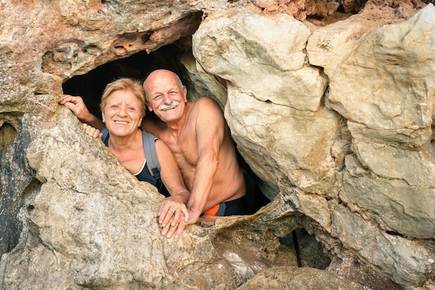 Senior happy couple having fun at the entrance of Kayangan Cave in Coron