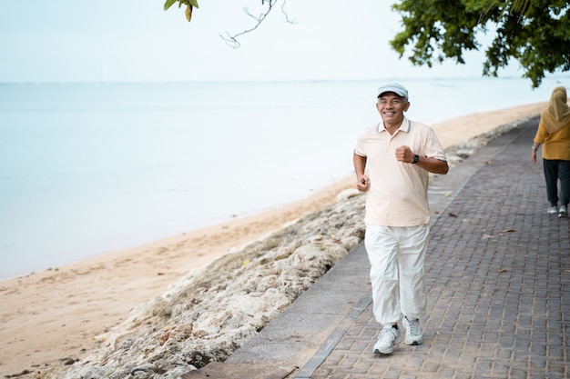 Senior male running and exercising outdoors