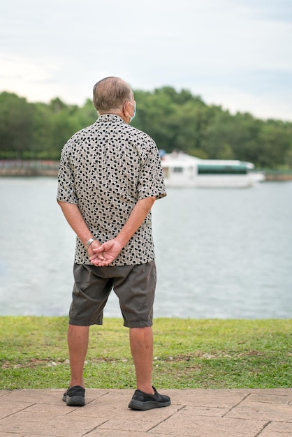 Senior man enjoying lake view