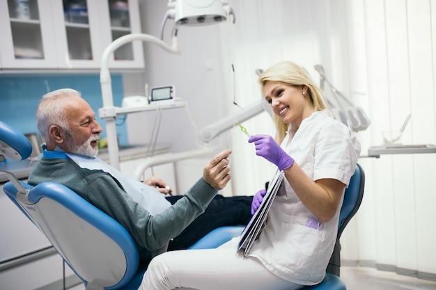 Senior man having dental treatment at dentist's office.