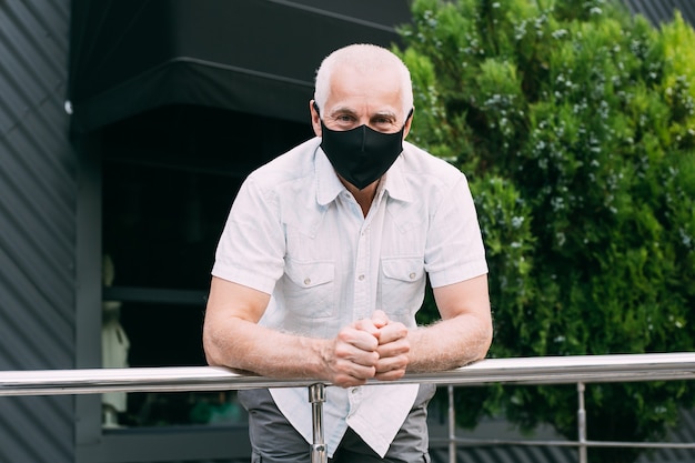 Senior man in medical mask on the street