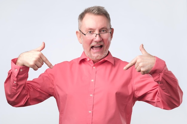 Senior man in red shirt and glasses is proud