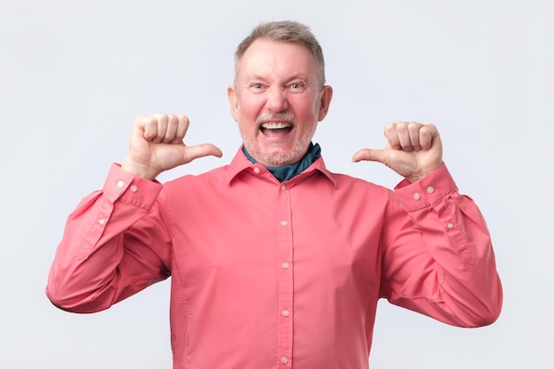 Senior man in red shirt looking confident