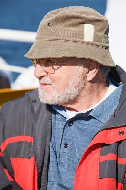 Senior man sitting on ship deck