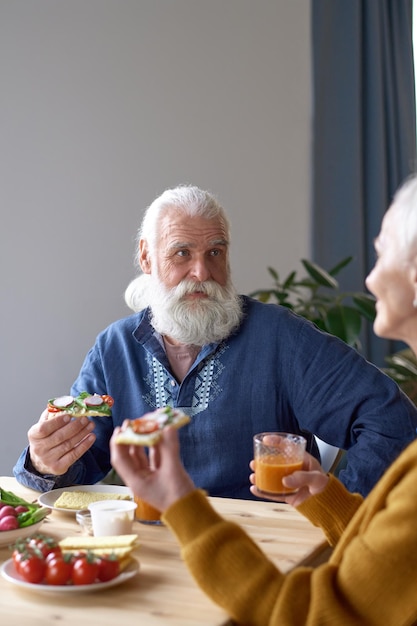 Senior man talking to his wife at lunch