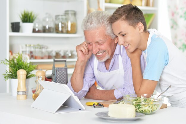 Senior man with grandson preparing dinner