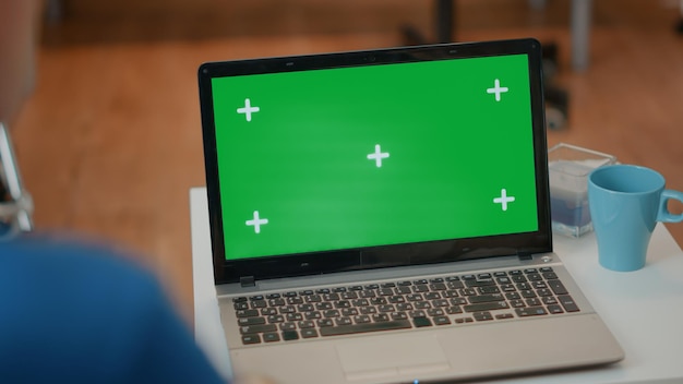 Senior man and woman looking at green screen on laptop. Elderly couple using blank copy space with isolated chroma key template and mock up background on computer. Technology on display