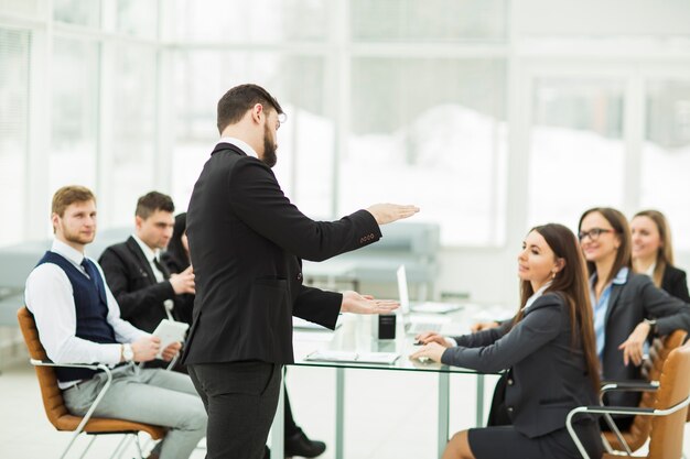 Senior Manager of the company holds a working meeting with business team in modern office. the photo has a empty space for your text.