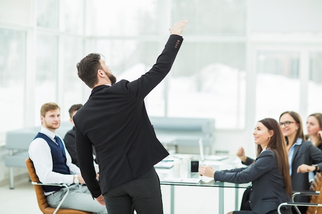 Senior manager of the company holds a working meeting with business team in modern office