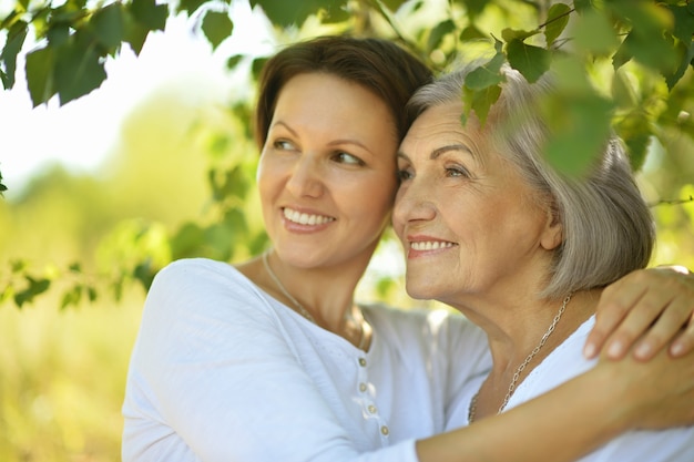 Senior Mother and her nice daughter in  park