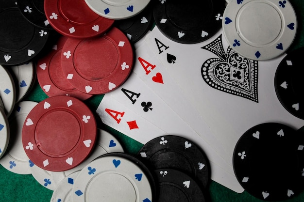 Senior Poker. Four playing cards, four aces and poker chips on a green casino table.