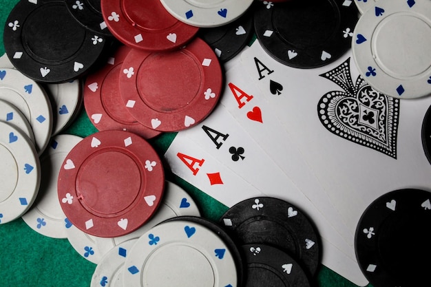 Senior Poker. Four playing cards, four aces and poker chips on a green casino table.