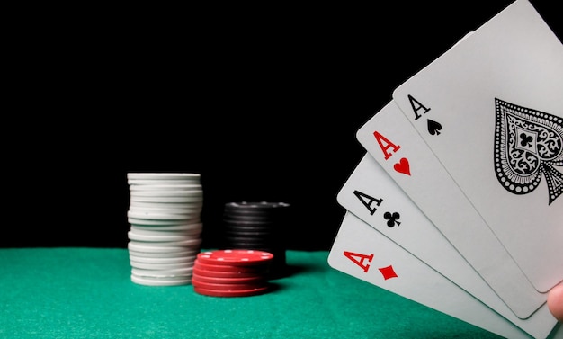 Senior Poker. Four playing cards, four aces and poker chips on a green casino table.