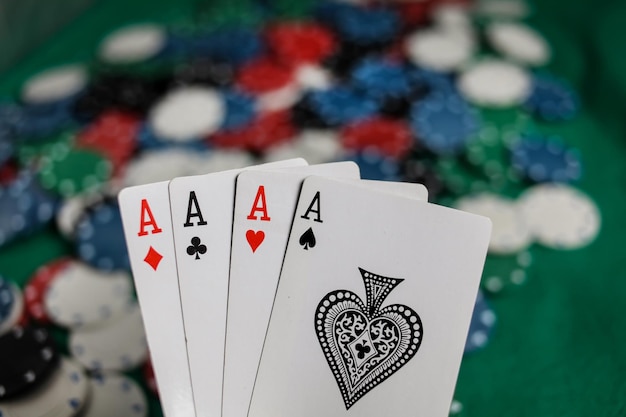 Senior Poker. Four playing cards, four aces and poker chips on a green casino table.