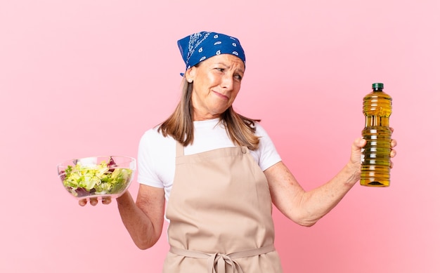 Senior pretty woman preparing a salad