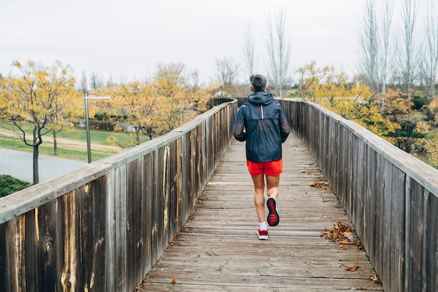 Senior retired man runs and performs exercise