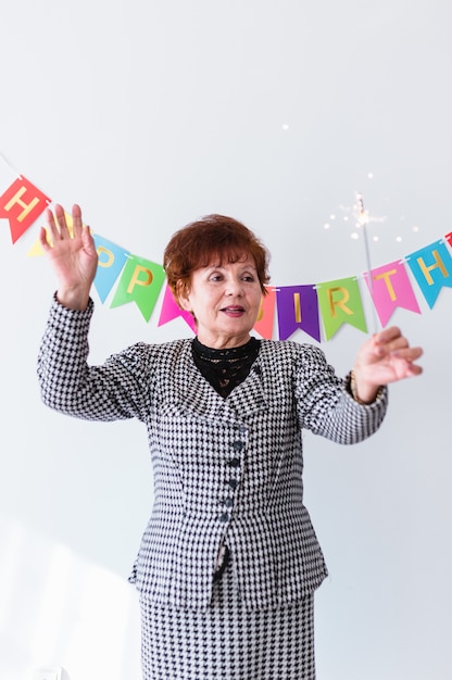 Senior woman celebrating her birthay at home