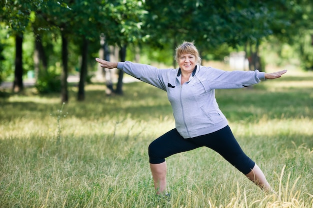 Senior woman doing yoga in the park