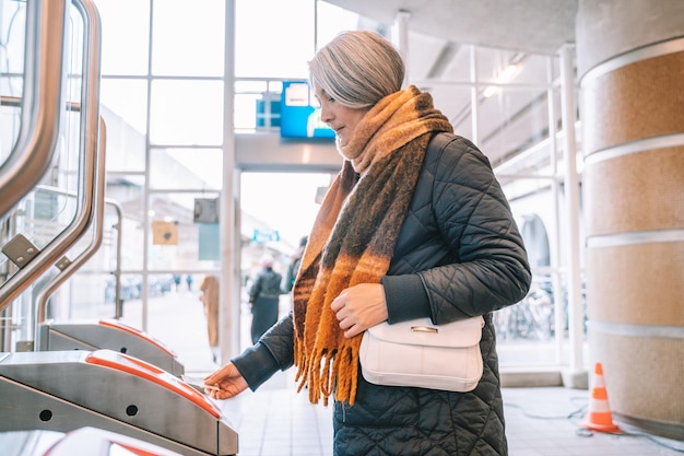 Senior woman enables ticket to takes the train