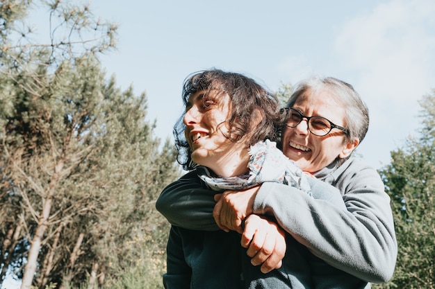 Senior woman and her daughter smiling and having fun on the forest during  happy mothers day