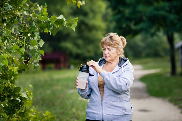 Senior woman holding a bottle of water