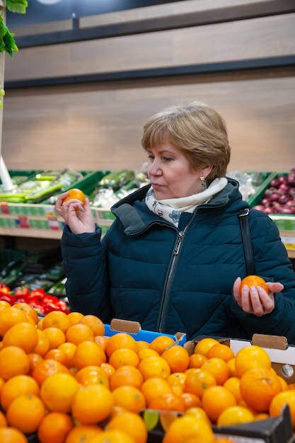 Senior woman picking out some vegetables in supermarket