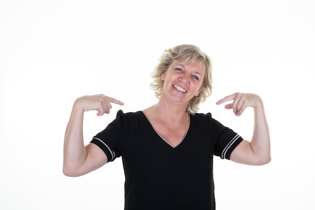 Senior woman portrait blonde looking proud positive and casual pointing to chest with finger hands