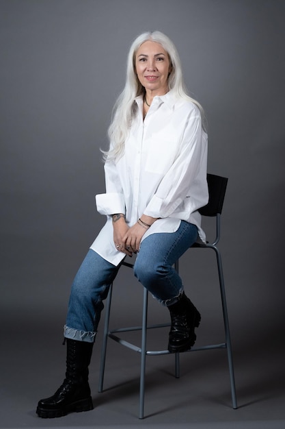 Senior woman posing on the chair