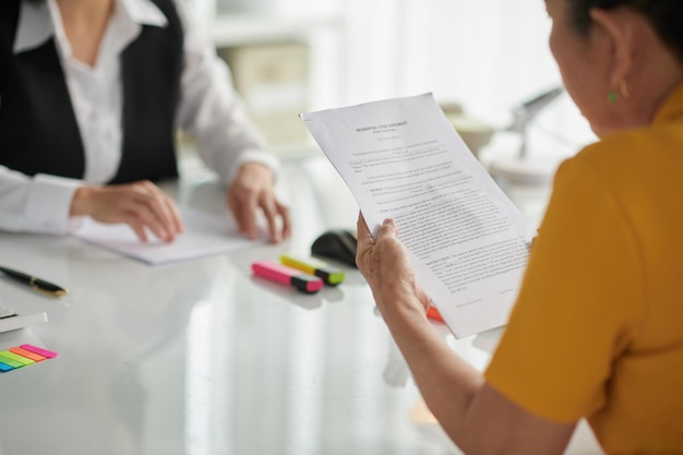 Senior Woman Reading Agreement