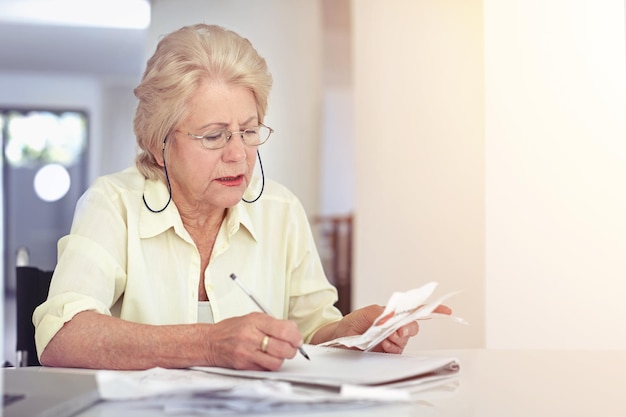 Senior woman retirement or planning budget or tax paperwork financial documents or receipt investment or savings Elderly person confused or finance or debt bills or pension management mockup