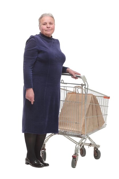 Senior woman at supermarket pointing at camera