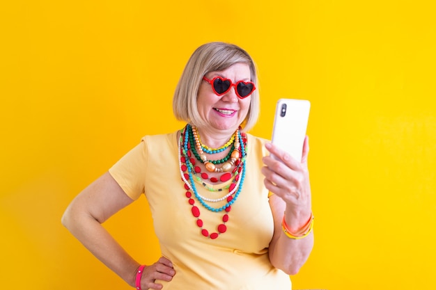 Senior woman talking on smartphone in stylish clothes concepts senior people