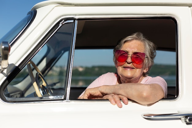 Senior woman traveling by car