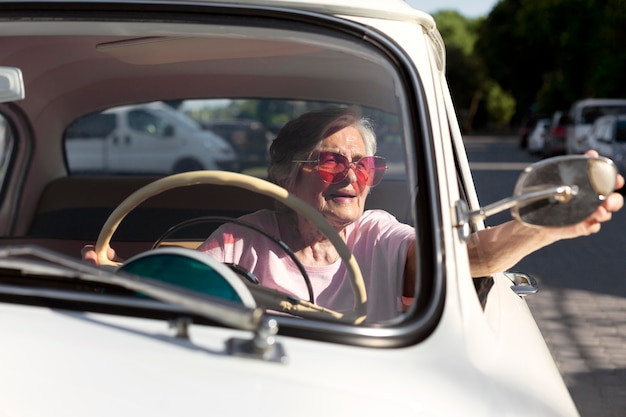 Senior woman traveling by car