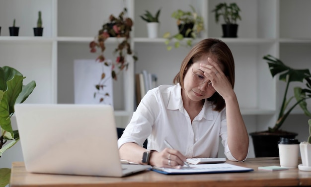 senior woman using laptop computer and serious at work