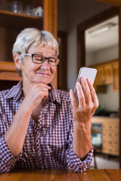 Senior woman using phone making video call