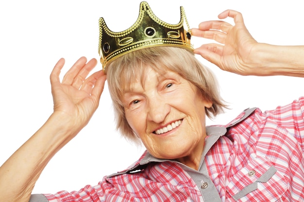 Senior woman wearing crown doing funky action