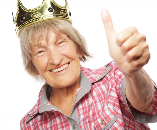 Senior woman wearing crown doing funky action