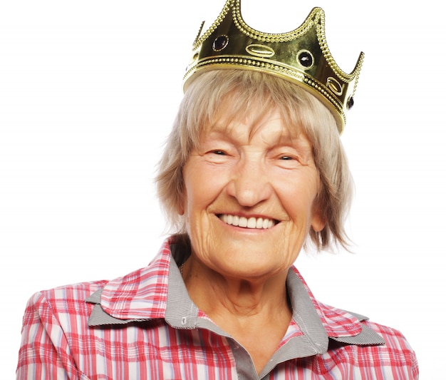 Senior woman wearing crown doing funky action