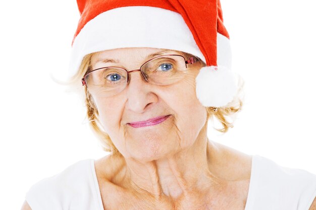 senior woman wearing Santa hat isolated over white background