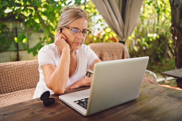 Senior woman working online with laptop