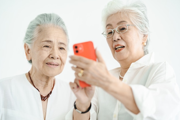 Senior women operating smartphone through trial and error