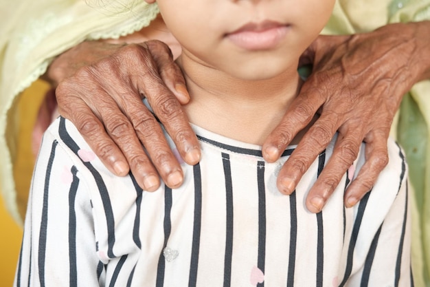 Senior women putting her hands on childs shoulder