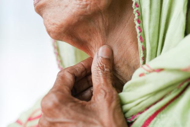 Senior women suffering throat pain close up